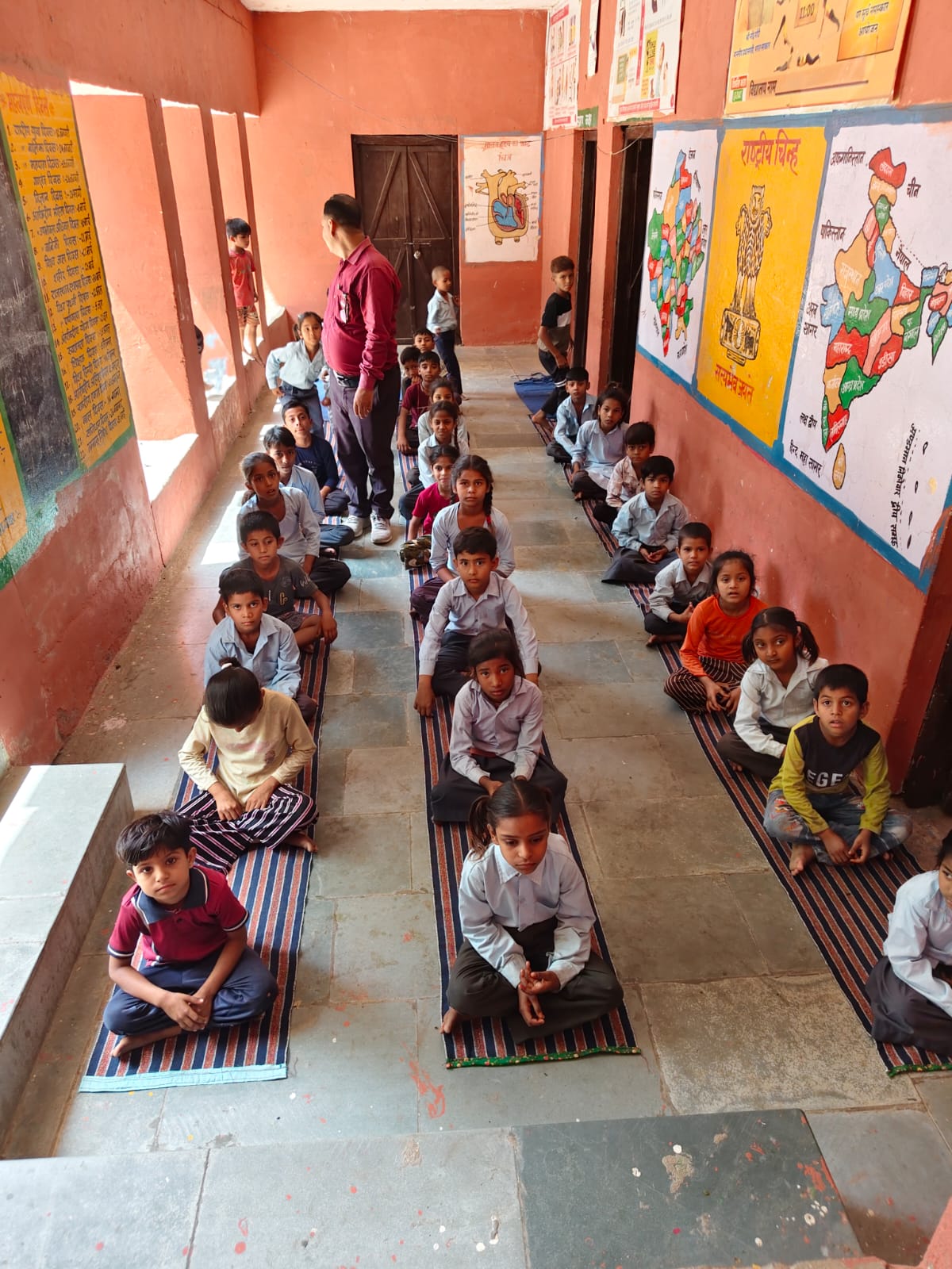 Children at Government Primary School, Bhopal Kalan holding up hygiene kits
