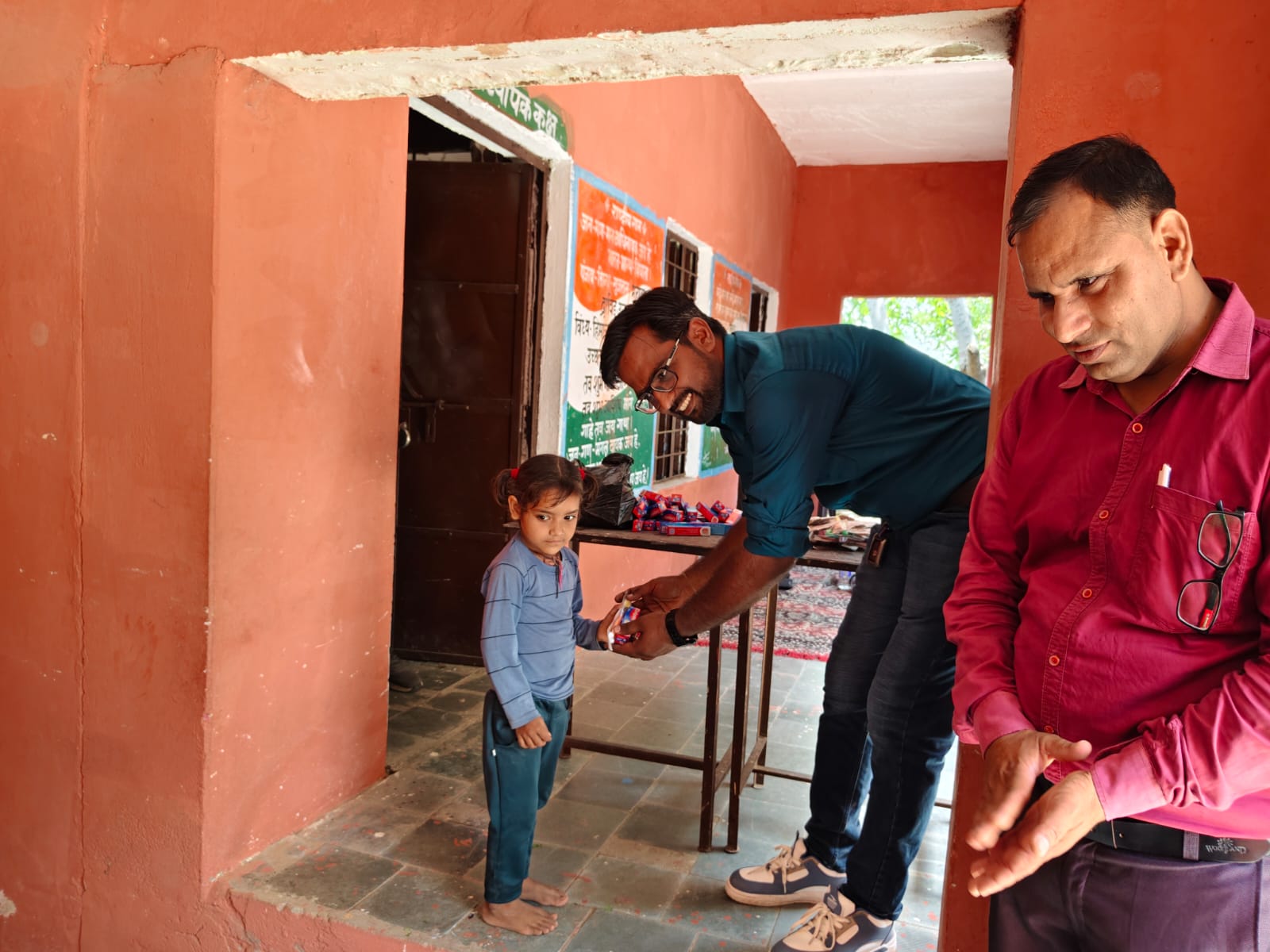 Community leaders and school staff gathered with children at the distribution drive